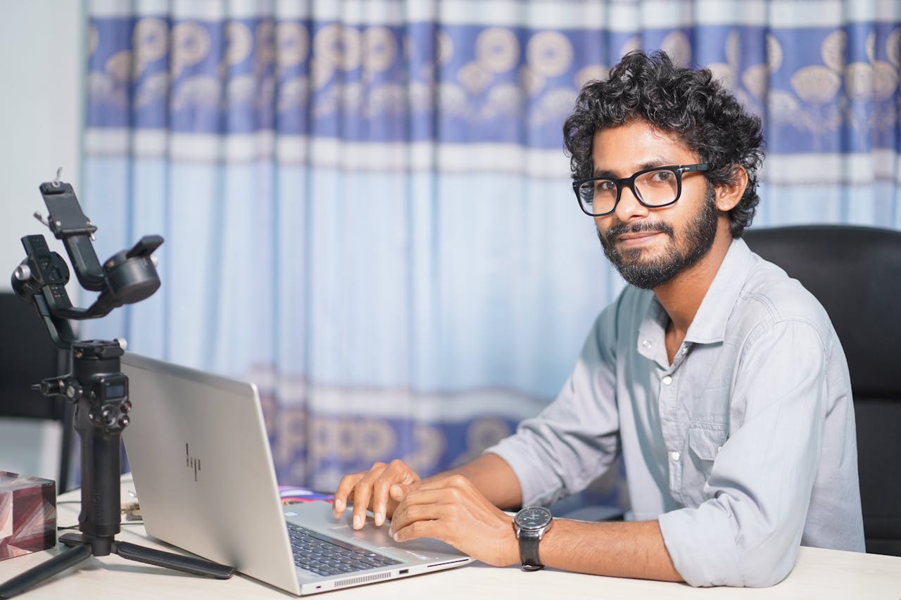 Portrait of a web developer working on a laptop, showcasing technical and professional skills.